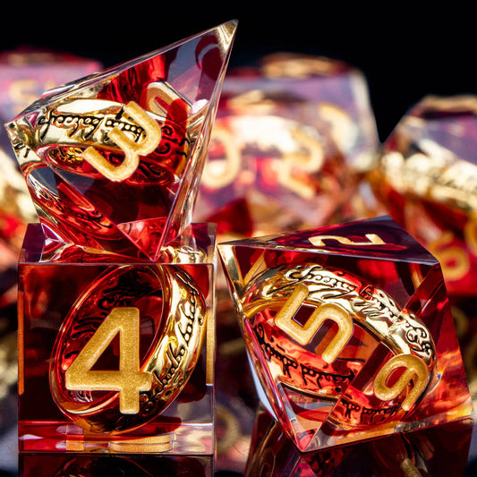 Transparent red dice with gold numbers and gold rings inside